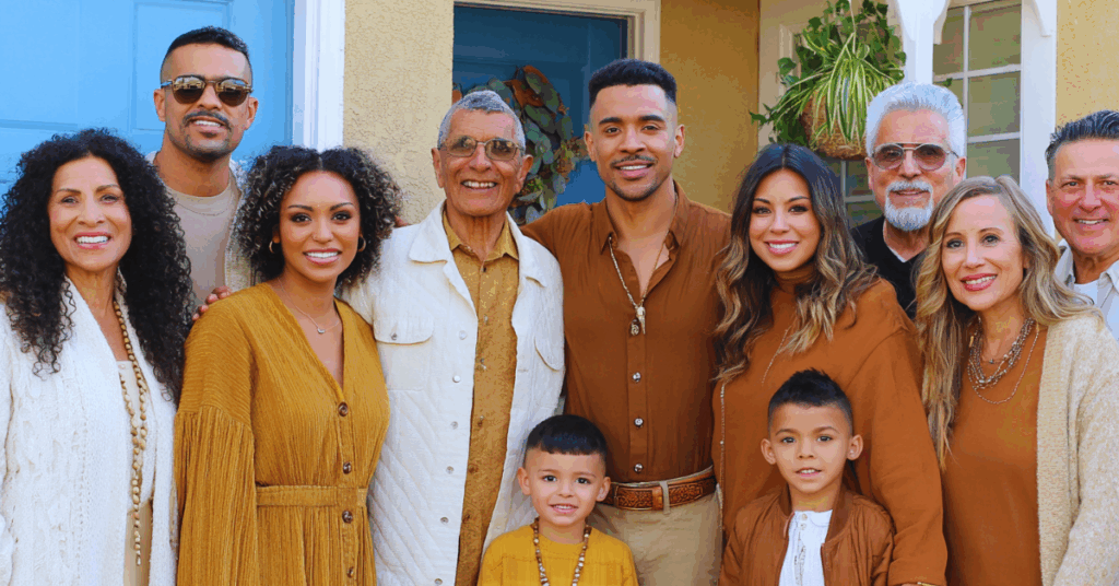 Smiling multigenerational Hispanic family standing together outside their home, symbolizing community, culture, and connection.