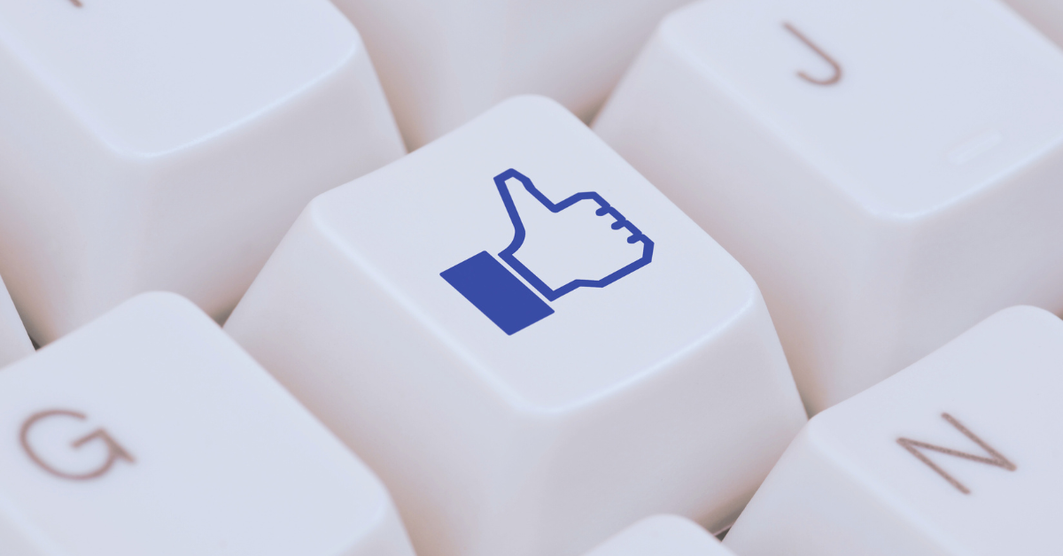 Keyboard key with Facebook thumbs-up icon symbolizing Meta ad engagement